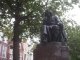 sad Spinoza statue in sad neighborhood
